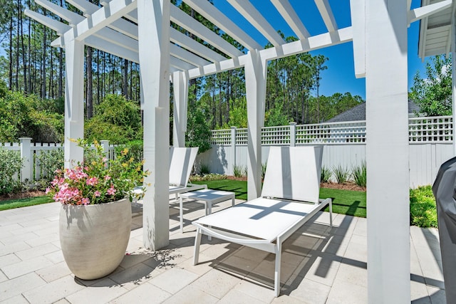 view of patio featuring fence and a pergola