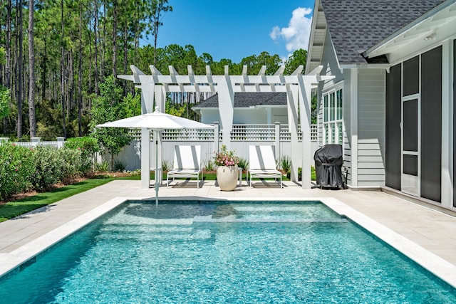 view of pool with a patio area, a pergola, and area for grilling