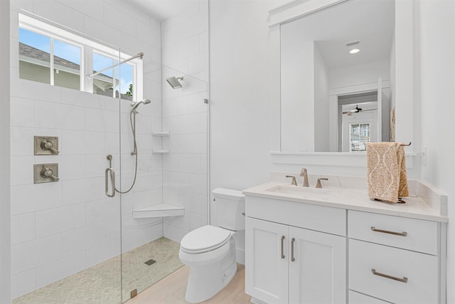 bathroom featuring toilet, walk in shower, and vanity