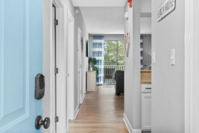 hall with light hardwood / wood-style floors