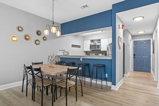 dining space with light hardwood / wood-style floors