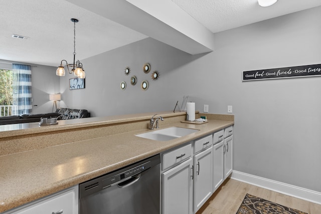 kitchen featuring light hardwood / wood-style flooring, dishwashing machine, white cabinetry, sink, and a textured ceiling