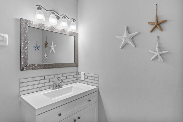 bathroom with tasteful backsplash and vanity