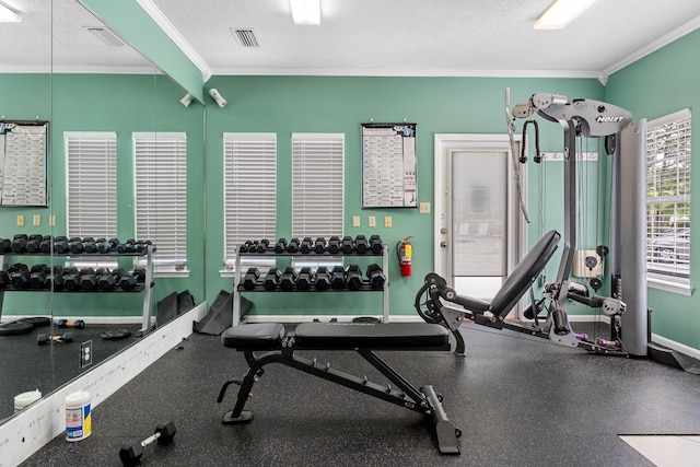 workout area with a textured ceiling and crown molding