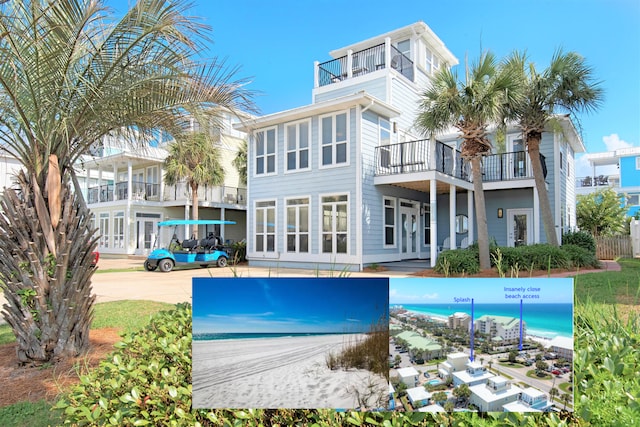 rear view of house featuring a water view and a beach view