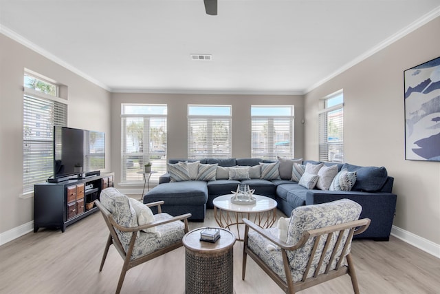 living area featuring baseboards, visible vents, crown molding, and light wood finished floors