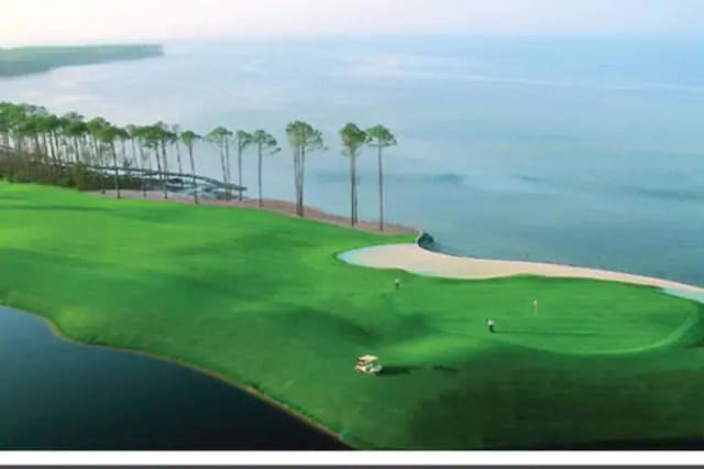 view of home's community featuring view of golf course and a water view