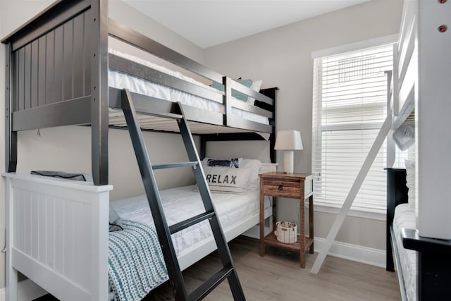 bedroom with baseboards and wood finished floors