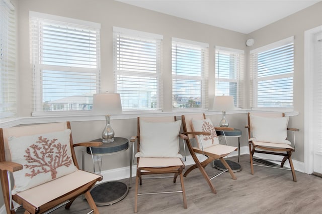 living area with baseboards and light wood finished floors