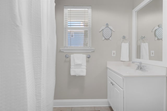 full bathroom with vanity and baseboards