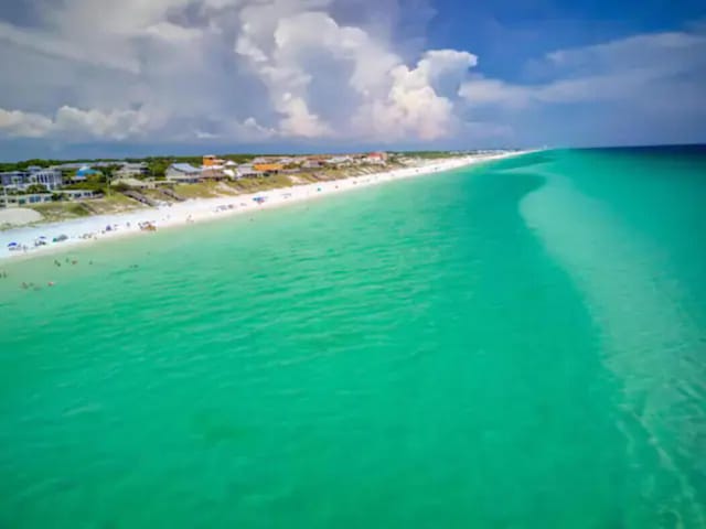 aerial view with a water view and a view of the beach