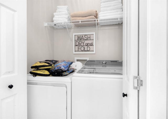 laundry room with laundry area and washing machine and clothes dryer