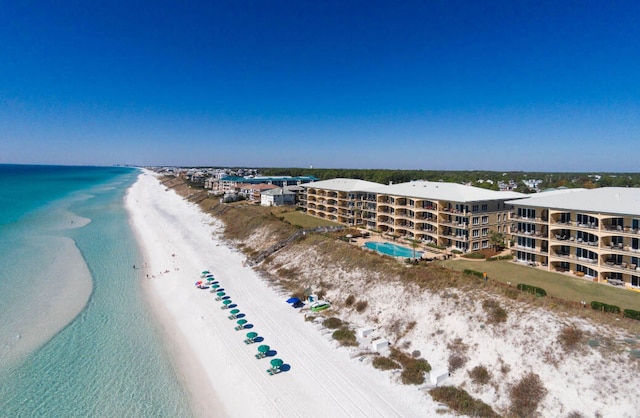 bird's eye view with a water view and a beach view