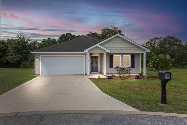 view of front of home with a lawn and a garage