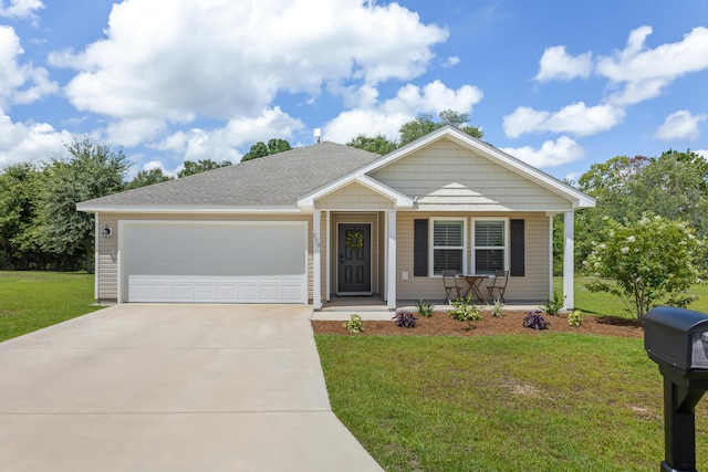 view of front of house with a garage and a front lawn