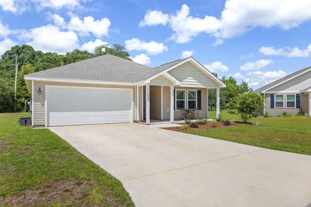 view of front of home featuring a front yard and a garage