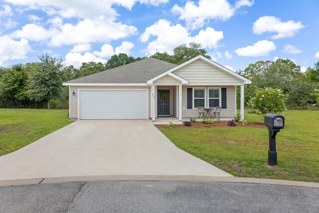 view of front of house with a front yard and a garage