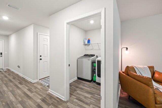 laundry area with wood-type flooring