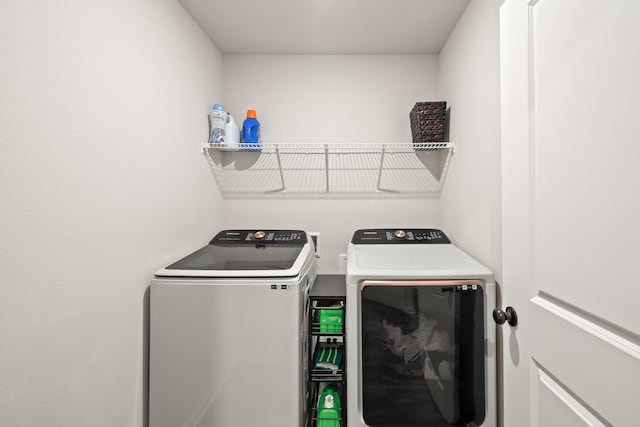 clothes washing area featuring independent washer and dryer