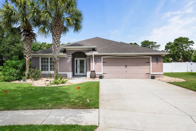 view of front of house with a garage and a front lawn