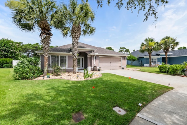 single story home with a garage and a front lawn