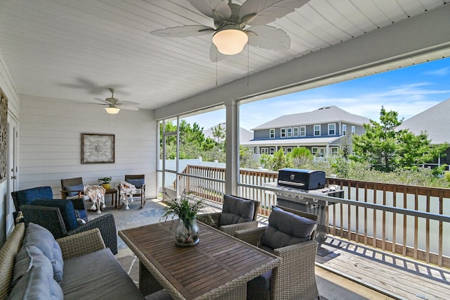 sunroom featuring ceiling fan