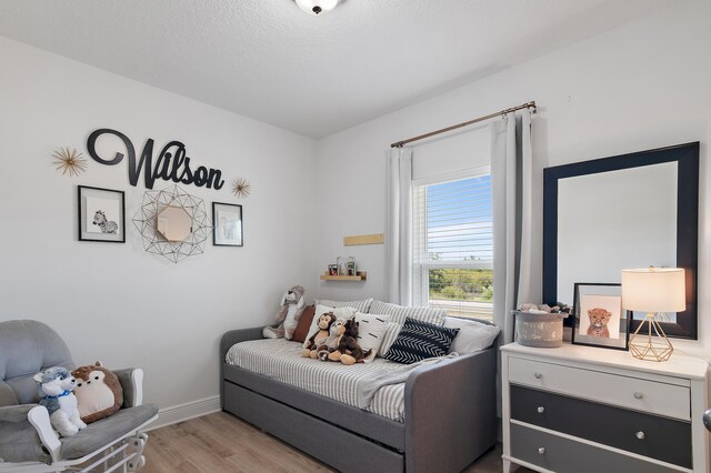 bedroom with light wood-type flooring