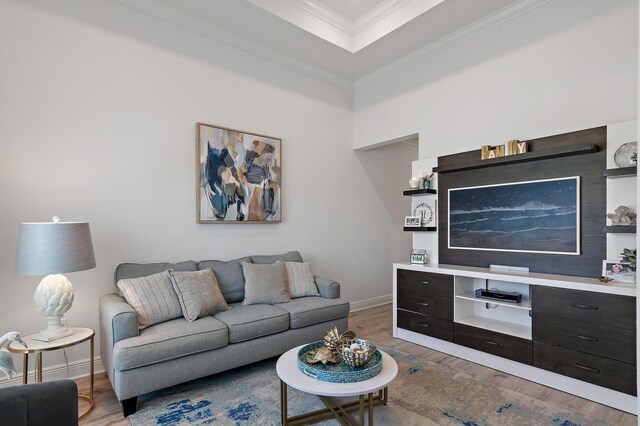 living room with dark wood-type flooring and ornamental molding