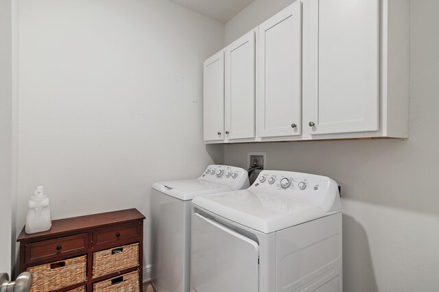 washroom with cabinets and separate washer and dryer