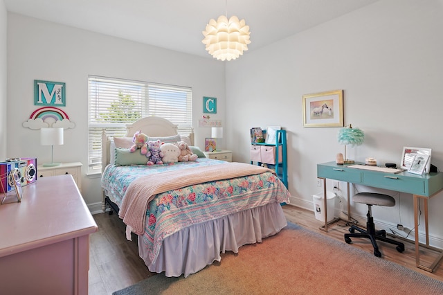 bedroom featuring hardwood / wood-style floors and an inviting chandelier