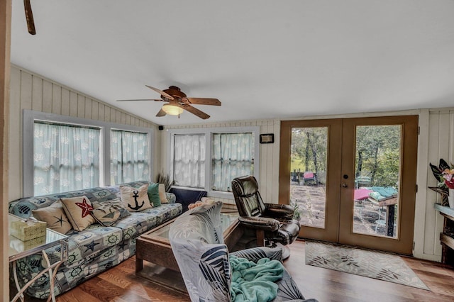 living room featuring light wood-type flooring, vaulted ceiling, french doors, and ceiling fan