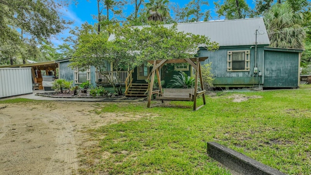 back of house with a lawn