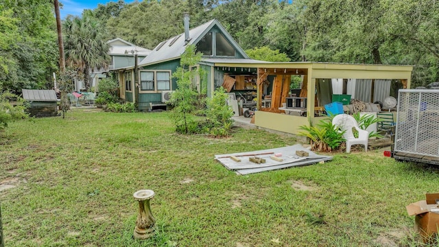 rear view of house featuring a yard