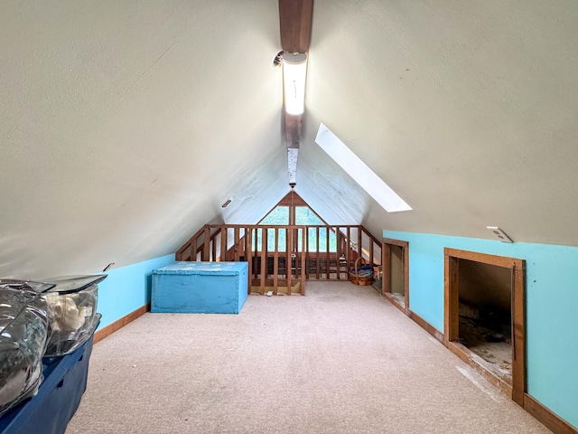 bonus room with carpet floors and vaulted ceiling with skylight