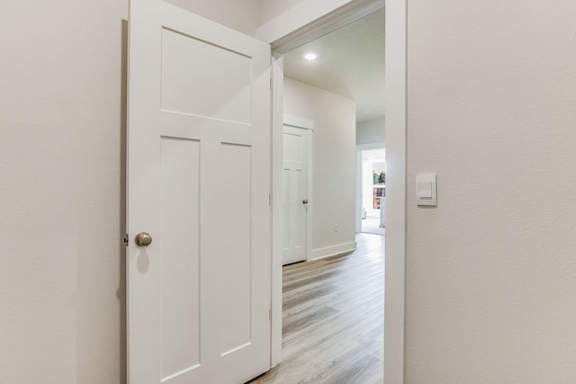 corridor with light wood-type flooring