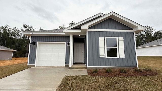 ranch-style house featuring a garage, a front yard, concrete driveway, and board and batten siding