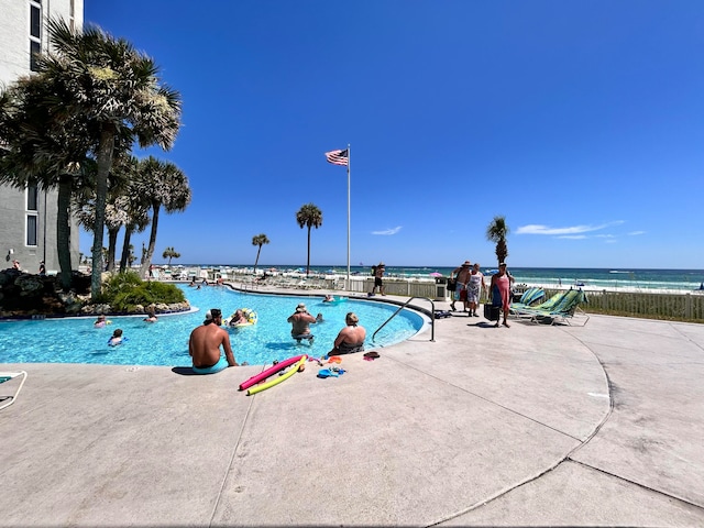 view of pool with a water view