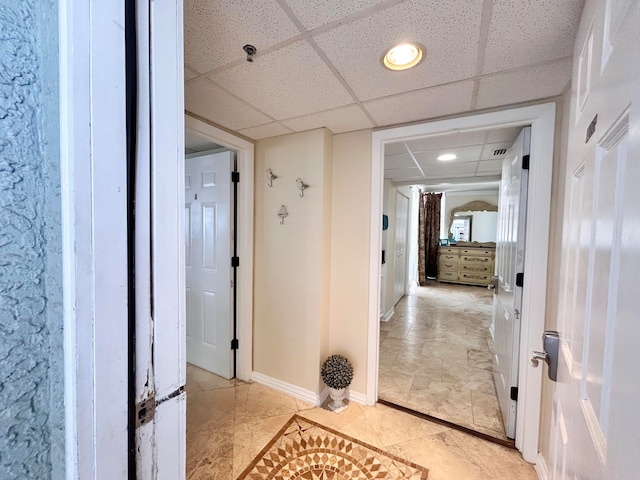 hallway featuring a paneled ceiling