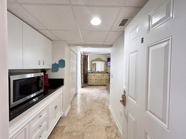 corridor featuring a paneled ceiling