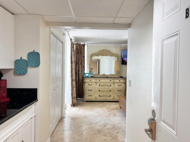 bathroom with a paneled ceiling and vanity