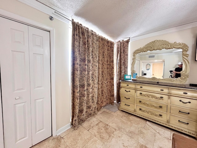 bathroom featuring vanity, a textured ceiling, and ornamental molding