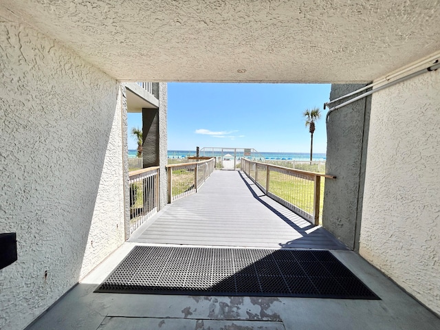 balcony featuring a water view and a view of the beach