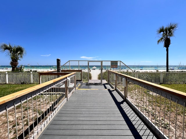 view of property's community featuring a water view and a beach view