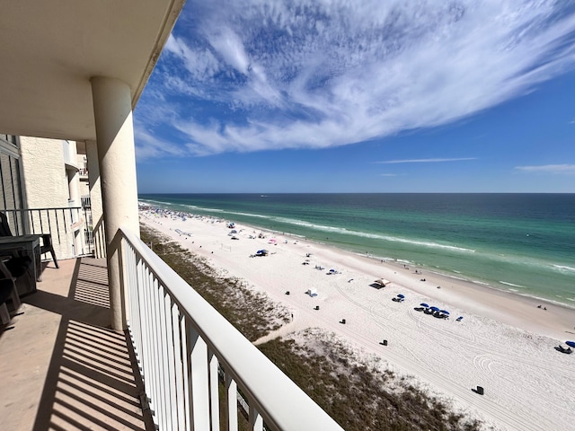 balcony with a water view and a beach view