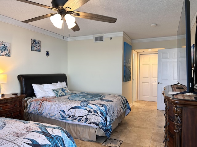 bedroom with ceiling fan, ornamental molding, and a textured ceiling