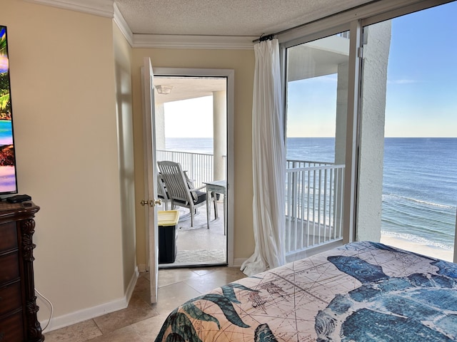 bedroom with a textured ceiling, a water view, and crown molding