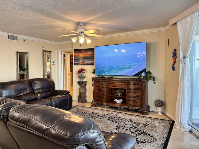 living room with ceiling fan, ornamental molding, and a textured ceiling