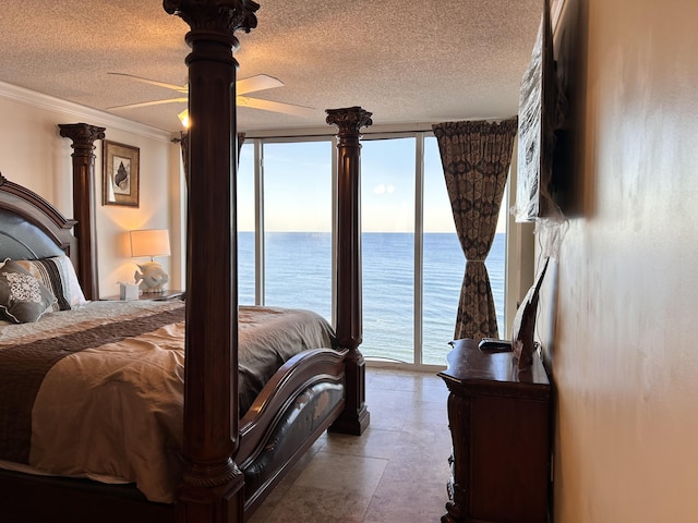 bedroom with a textured ceiling, ceiling fan, access to exterior, and crown molding