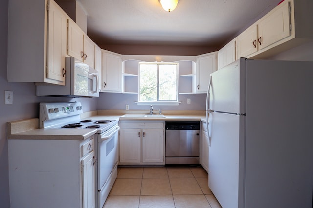 kitchen with white cabinetry, light tile patterned floors, sink, and white appliances