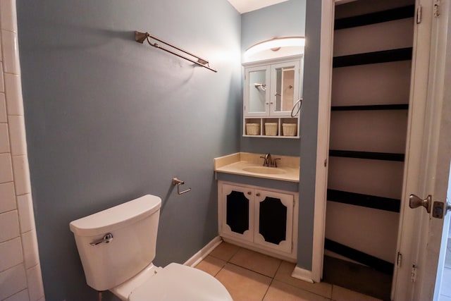 bathroom with tile patterned flooring, toilet, and vanity